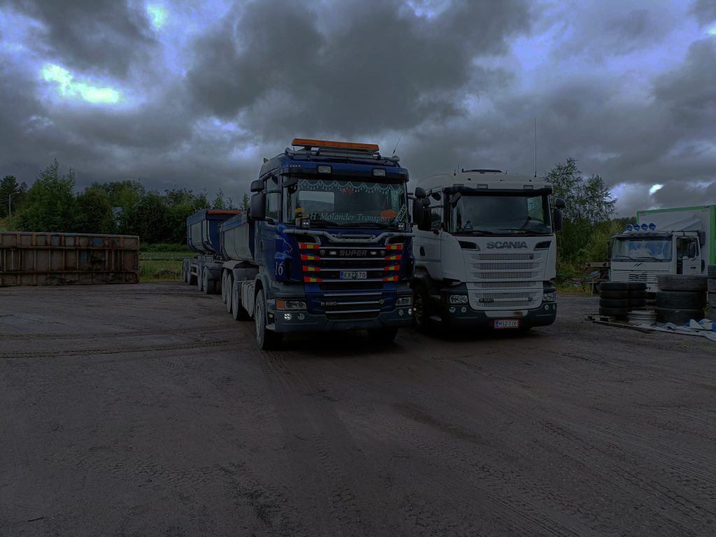 en bild som är två lastbilar i mörket